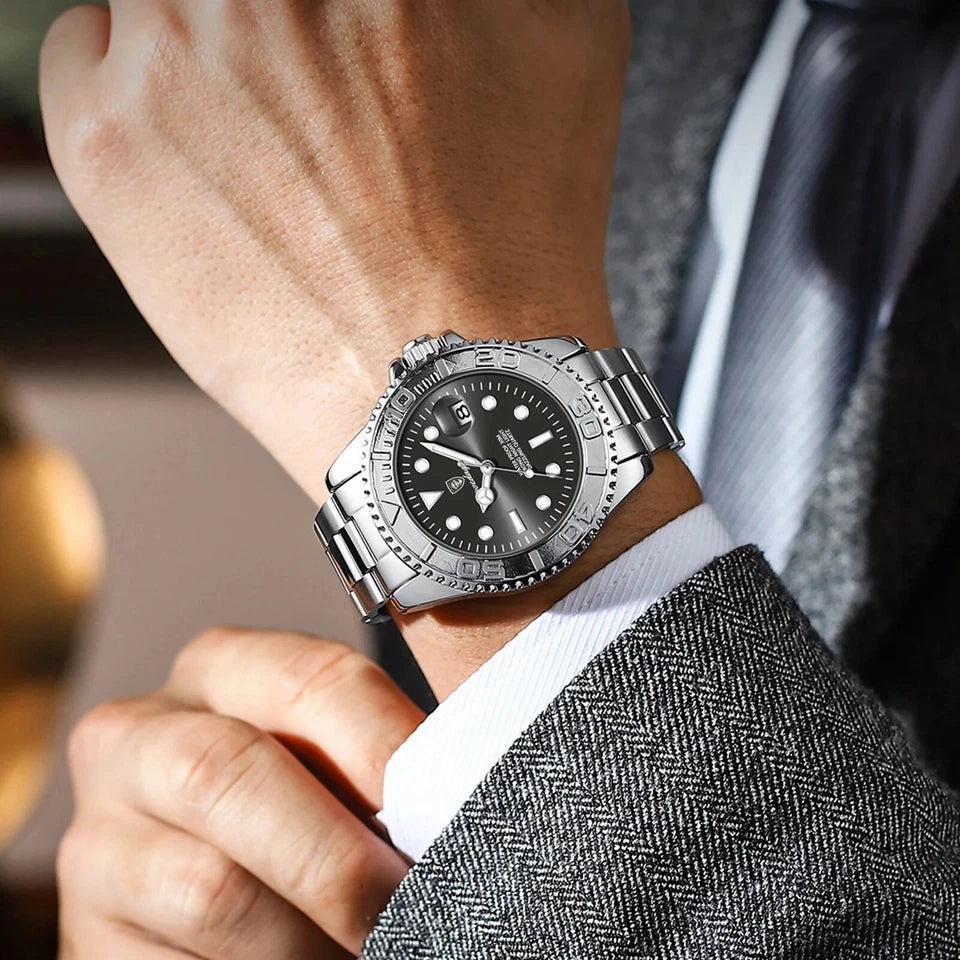 Close-up of a person wearing a silver wristwatch with a dark face.