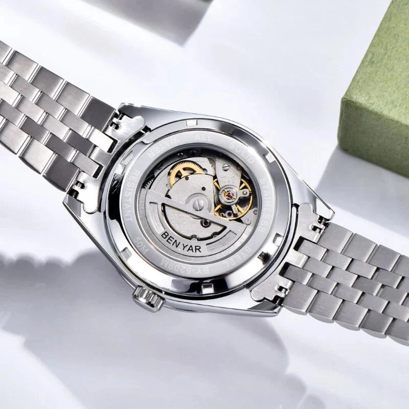 Silver watch with visible mechanism on a white background