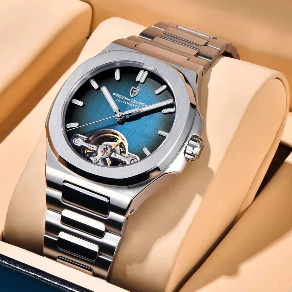Silver watch with blue face on a beige cushion