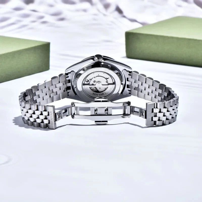 Silver watch with a detailed face on a light background