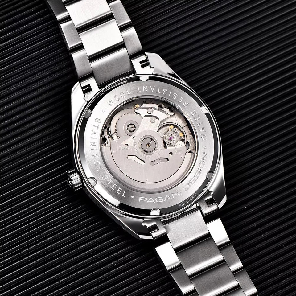 Close-up of a silver watch with visible brand name on a black textured background