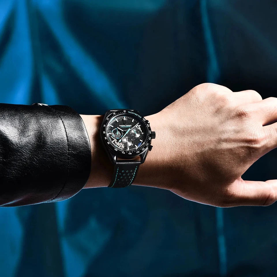 Hand wearing a black wristwatch with a blue background