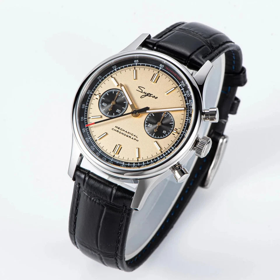 Wristwatch with black leather strap and beige dial on a white background
