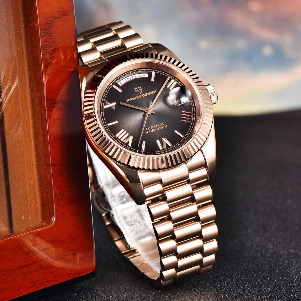 Rose gold watch with black dial on a dark surface