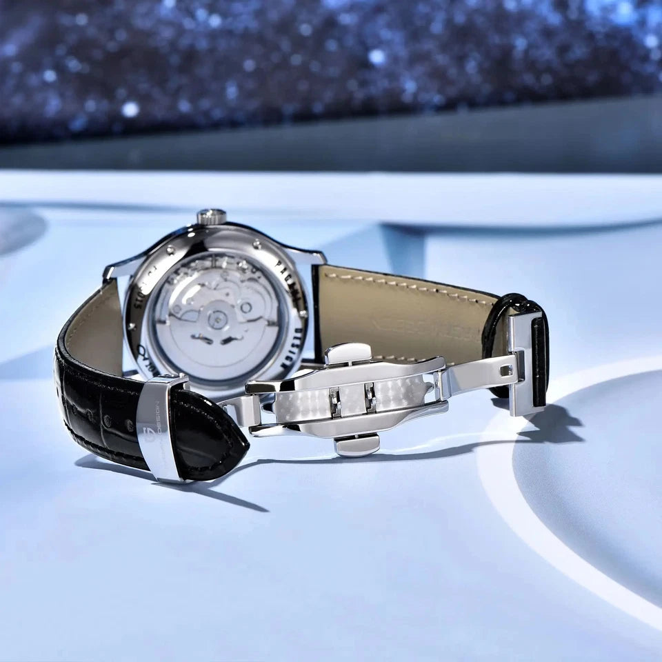 Luxury watch with black leather strap on a reflective surface