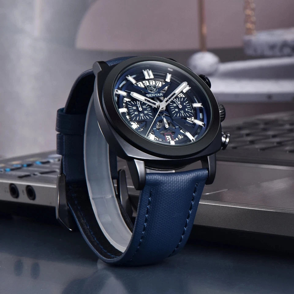 Blue wristwatch with black strap on a blurred background