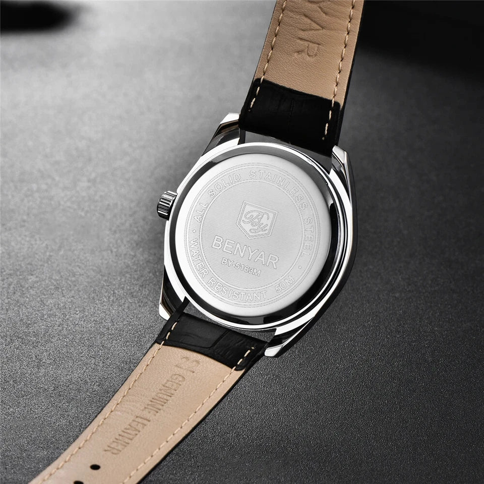 Wristwatch with beige leather strap and silver case on a gray background