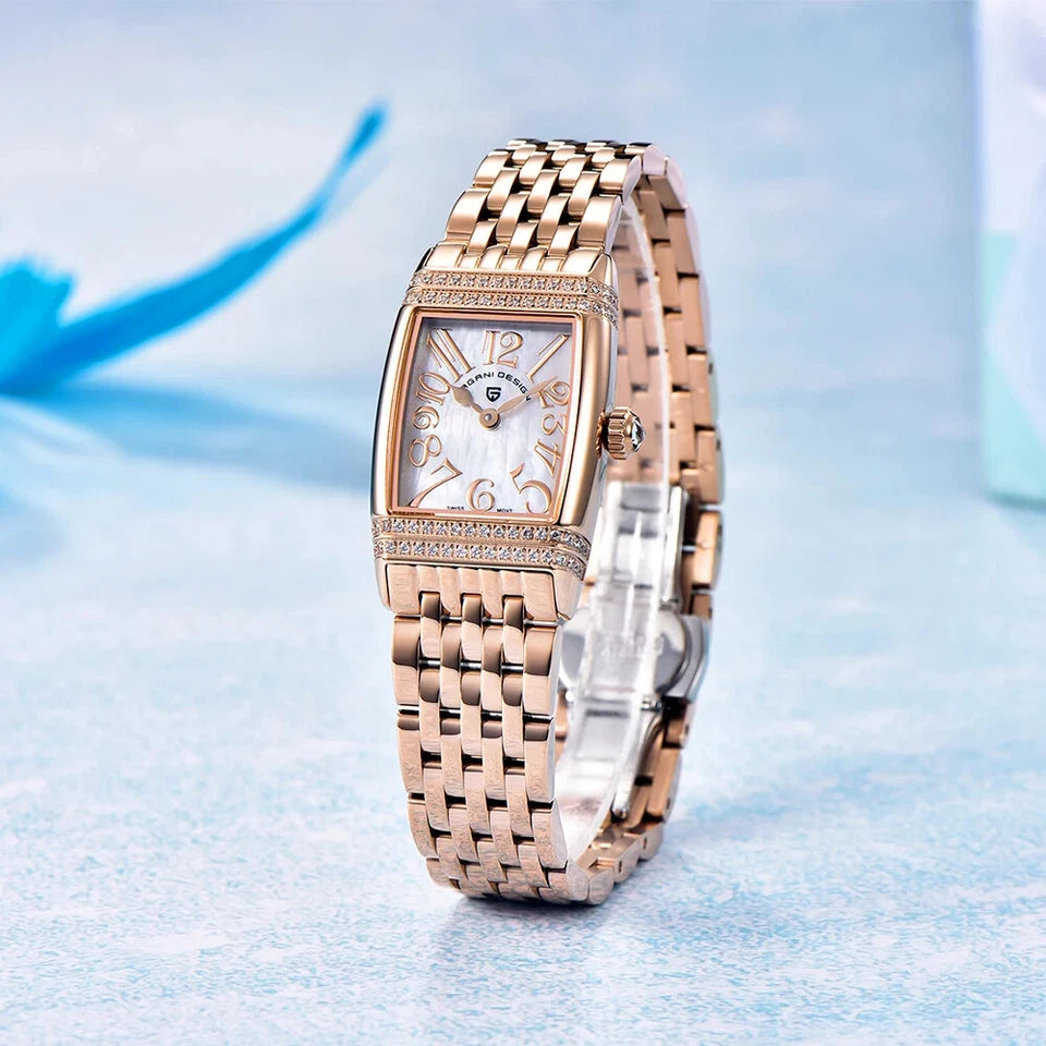 Rose gold watch with diamond accents on a light blue background