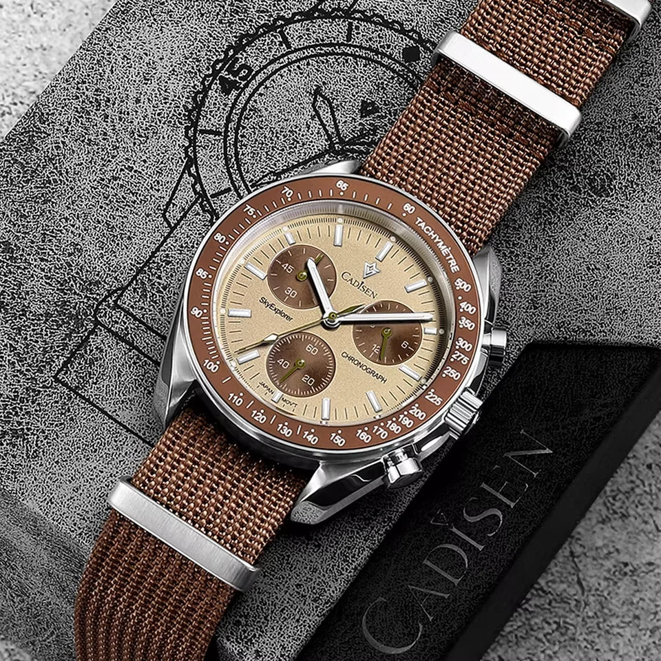 Watch with brown strap and beige dial on a textured surface