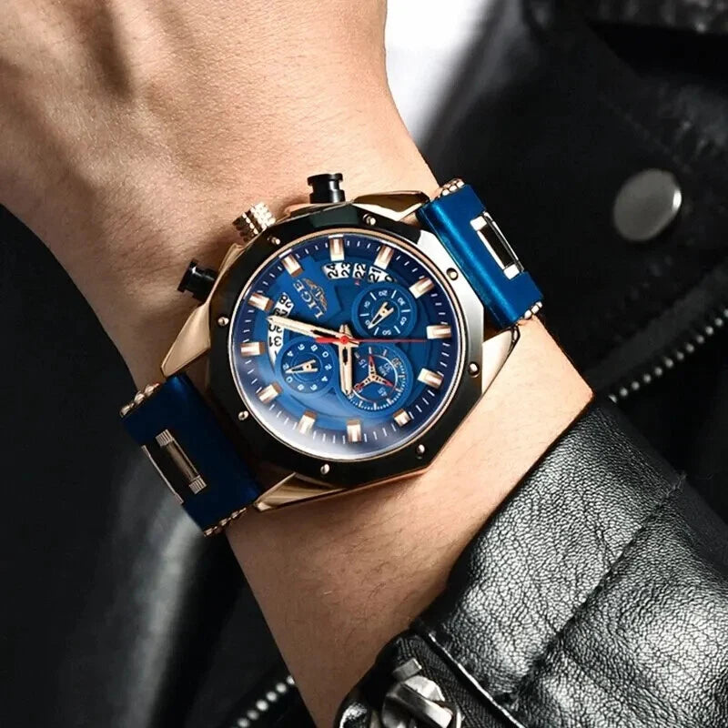 Close-up of a wrist wearing a blue and gold watch with a dark background