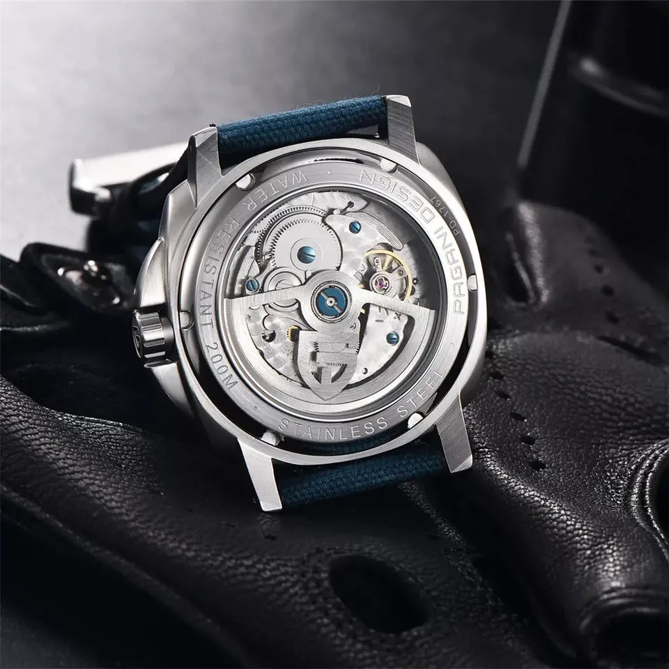 Close-up of a mechanical watch on a textured surface