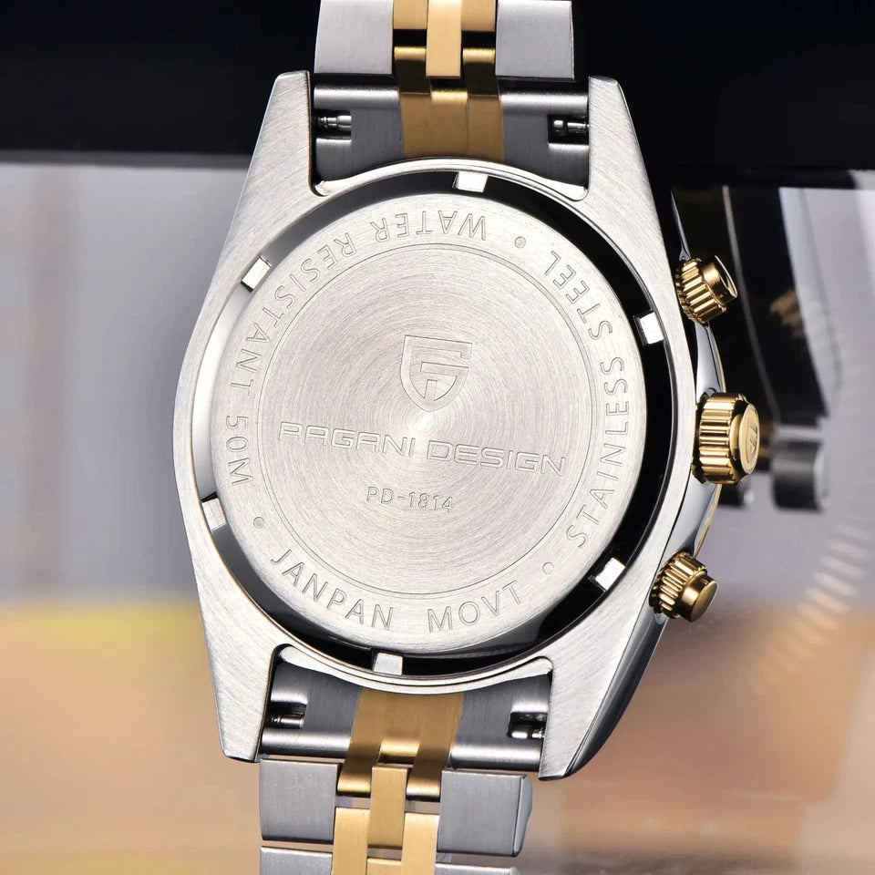 Close-up of a silver and gold watch with brand engraving on a blurred background