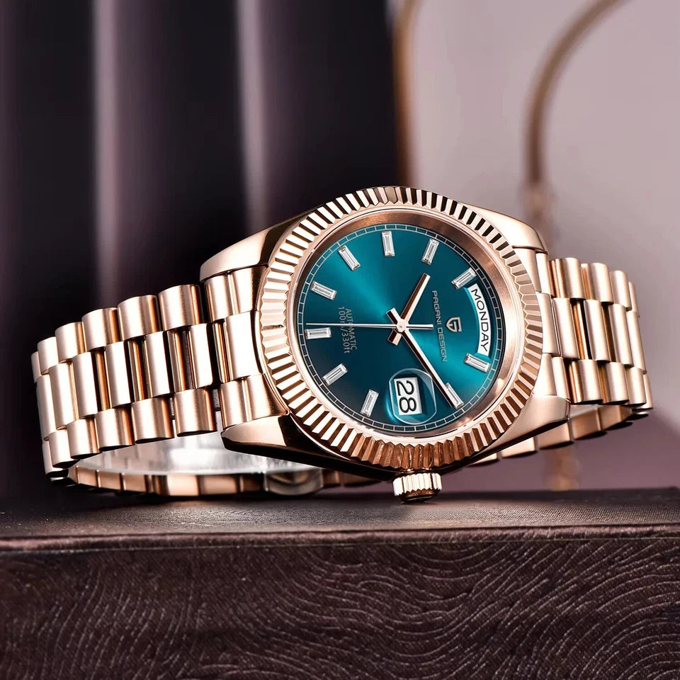 Rose gold watch with a blue face on a dark surface