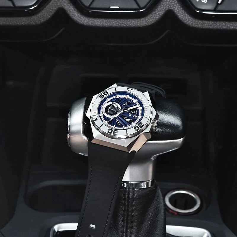 Luxury watch with black strap and silver case on a car gear shift