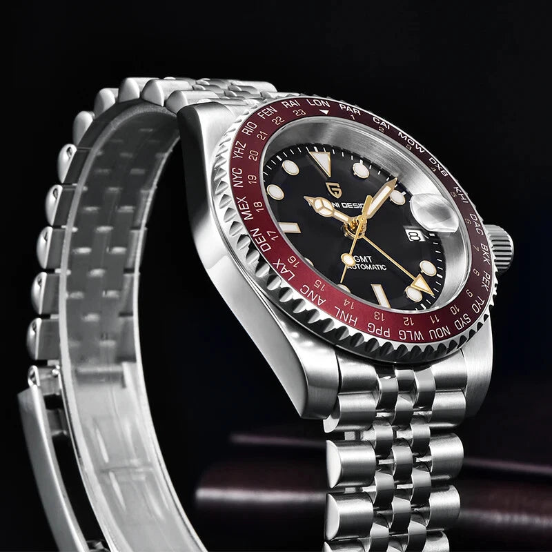 Silver watch with a black and red face on a dark background