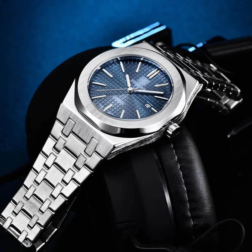 Silver watch with blue face held by a gloved hand against a dark background