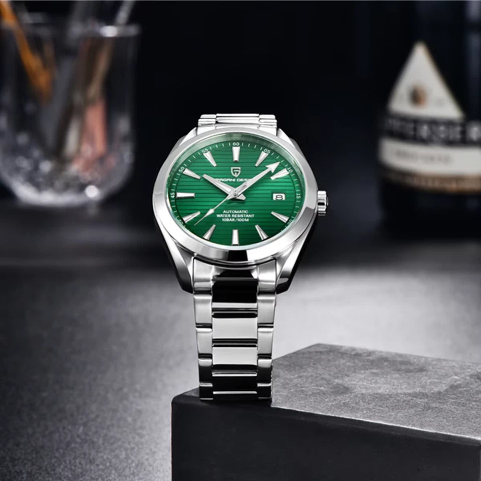 Silver watch with a green dial on a dark surface