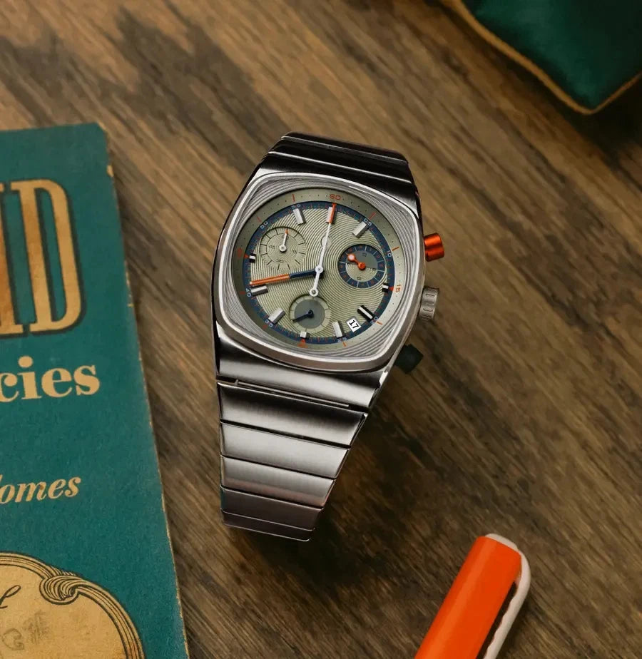 Silver wristwatch with a detailed face on a wooden surface