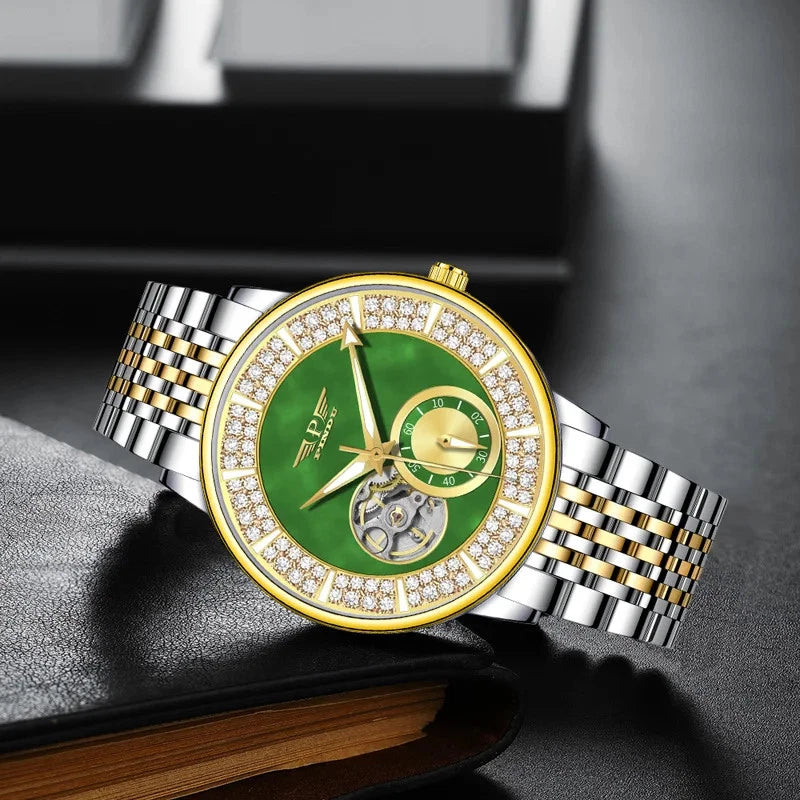 Luxury watch with green face and gold accents on a dark surface