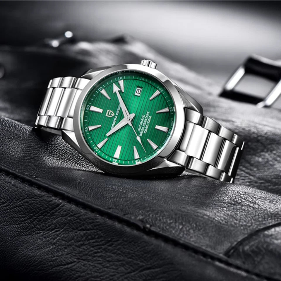 Green wristwatch with silver metal strap on a textured surface