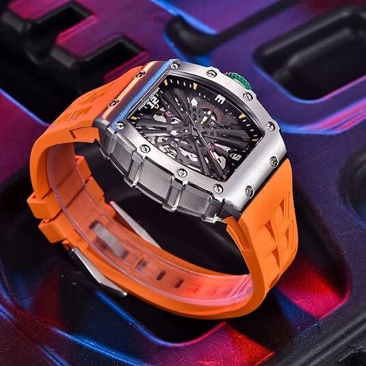 Watch with orange strap and silver case on a colorful background