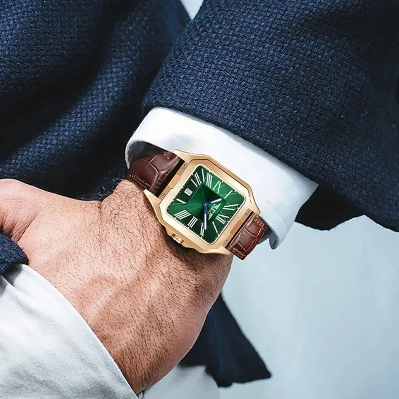 Luxury watch with green face and brown strap on a person's wrist, wearing a suit.