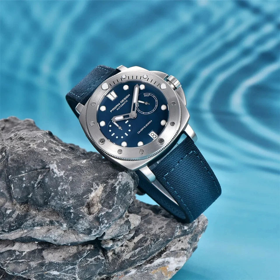 Blue watch with silver case on a rock with water background