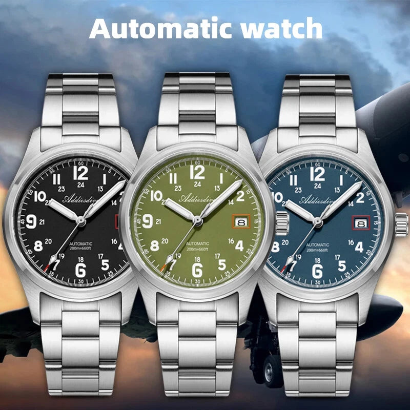 Three automatic watches with different colored faces on a blurred background