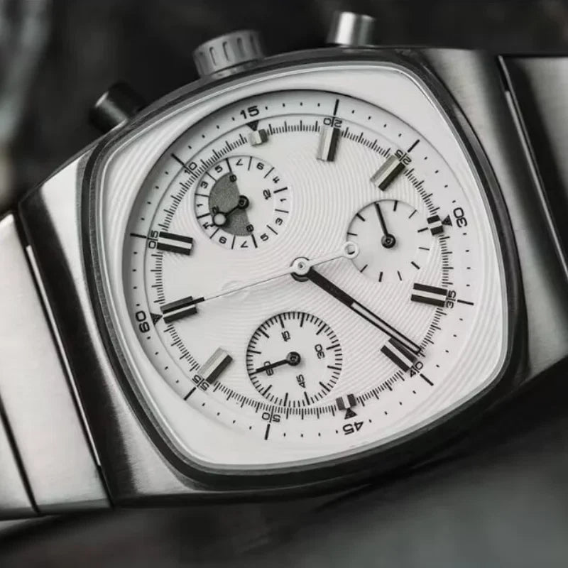 Close-up of a detailed wristwatch with a white face and metallic case.