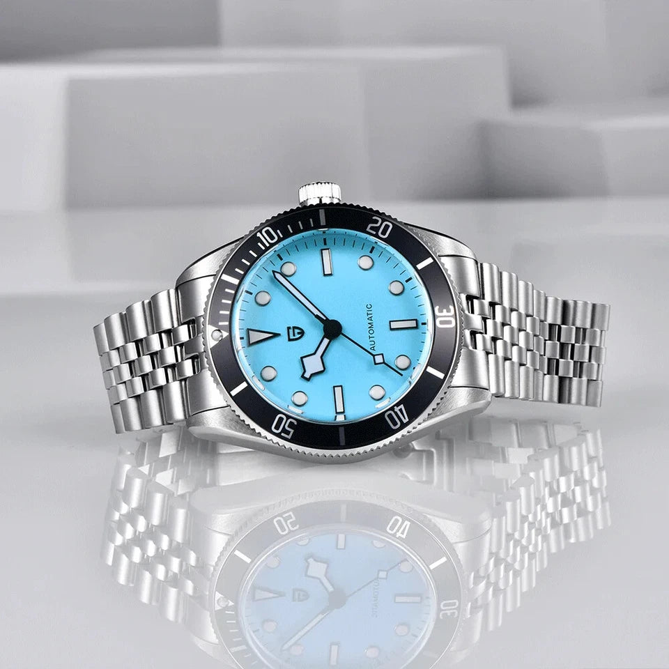 Silver watch with a blue face on a reflective surface