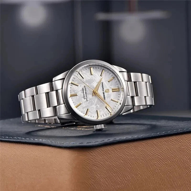 Silver watch with a detailed face on a dark surface