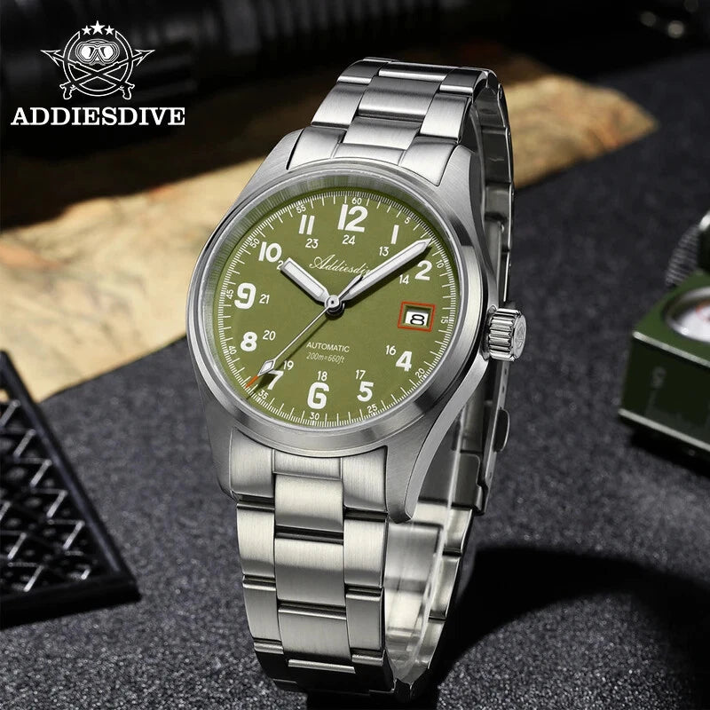 Silver watch with green dial on a textured surface, featuring the ADDIESDIVE brand.