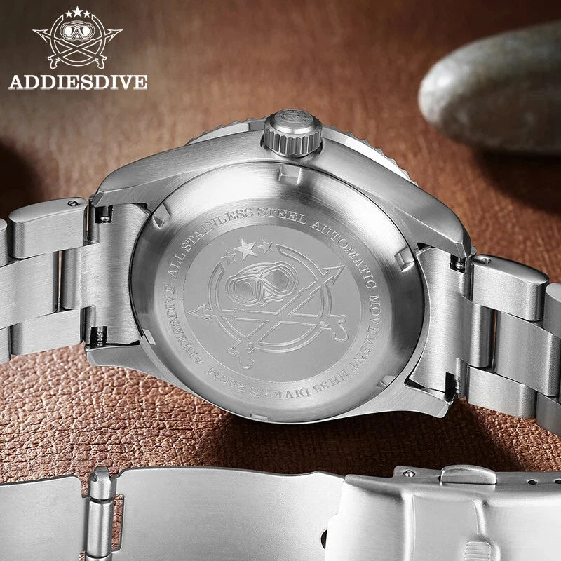 Close-up of a silver watch with engraved details on a brown leather background, featuring the AddiesDive brand.
