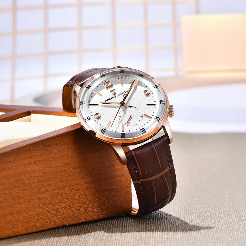 Watch with brown leather strap and white face on a wooden surface