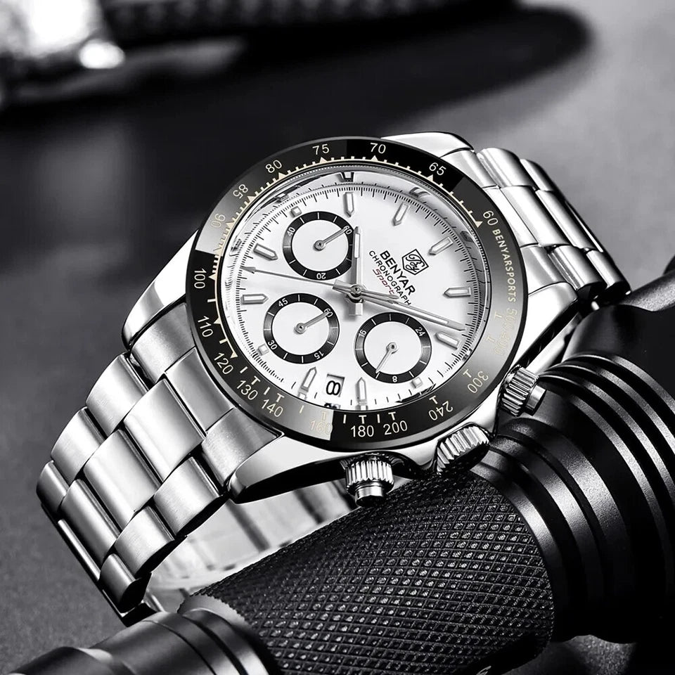 Silver watch with detailed face on a blurred background