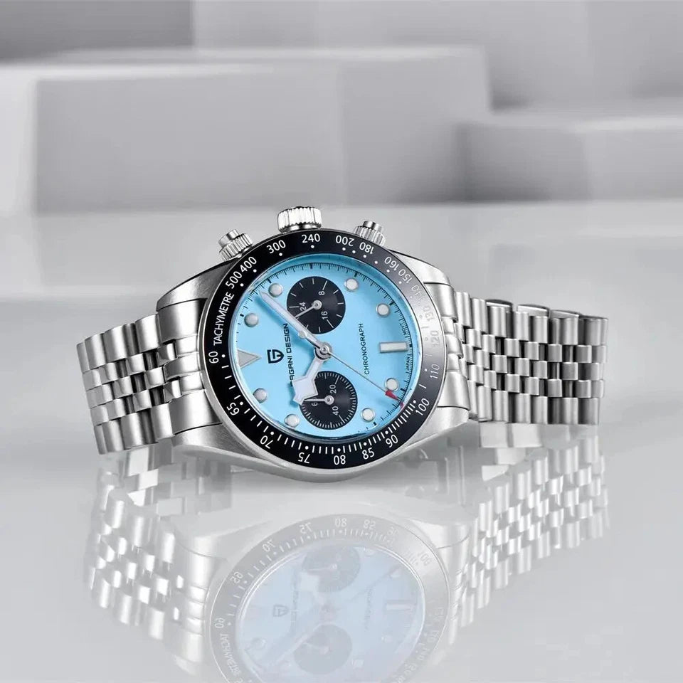 Silver watch with a blue face on a reflective surface