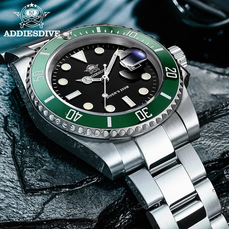 Silver watch with green bezel and black dial on a textured surface, featuring ADDIESDIVE branding.