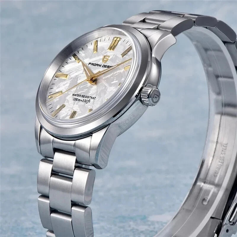 Silver wristwatch with a detailed face on a light blue background