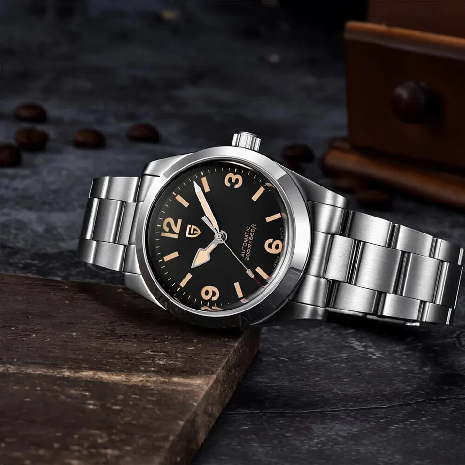 Silver watch with black dial on a dark surface