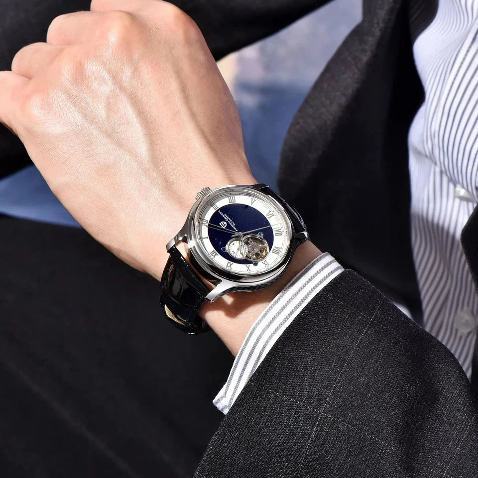 Close-up of a person wearing a luxury watch with a black strap and silver case.