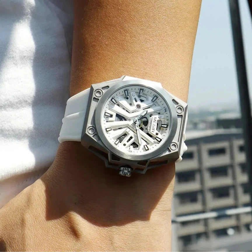 White Megir watch on a wrist with a blurred cityscape background