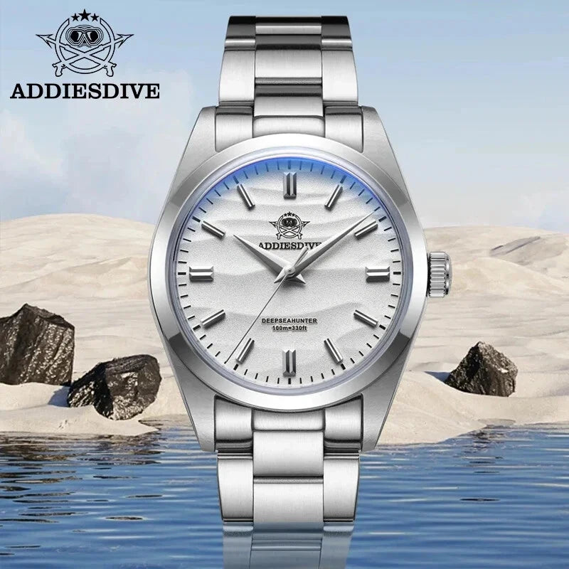 Silver watch with white face on a beach background, featuring ADDIESDIVE brand.