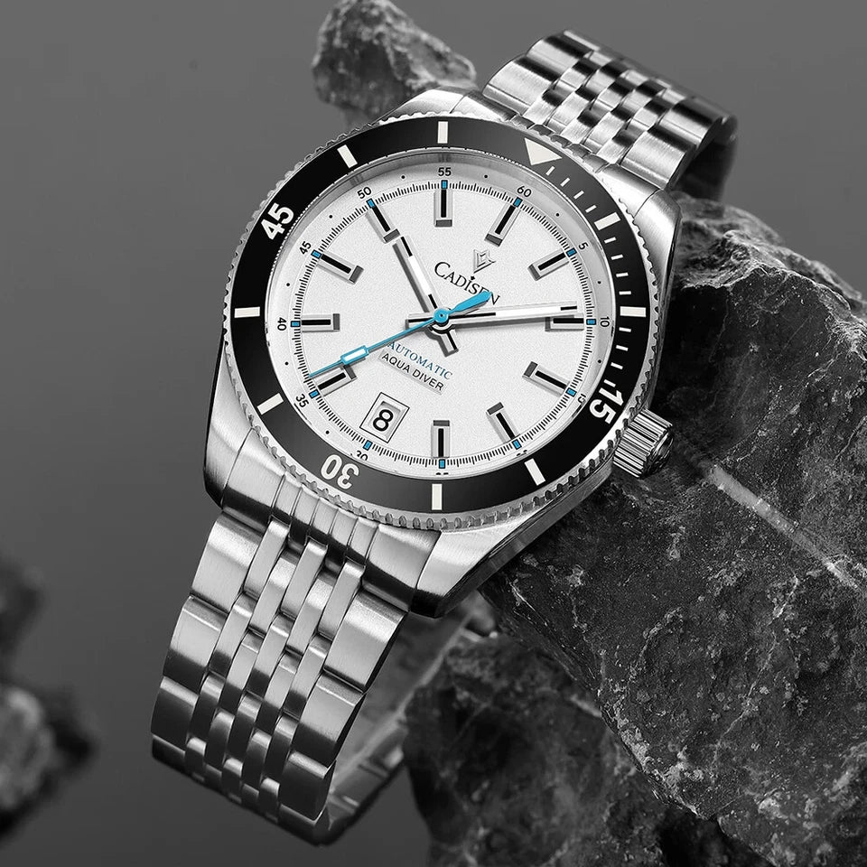 Silver watch with a white face on a dark stone surface