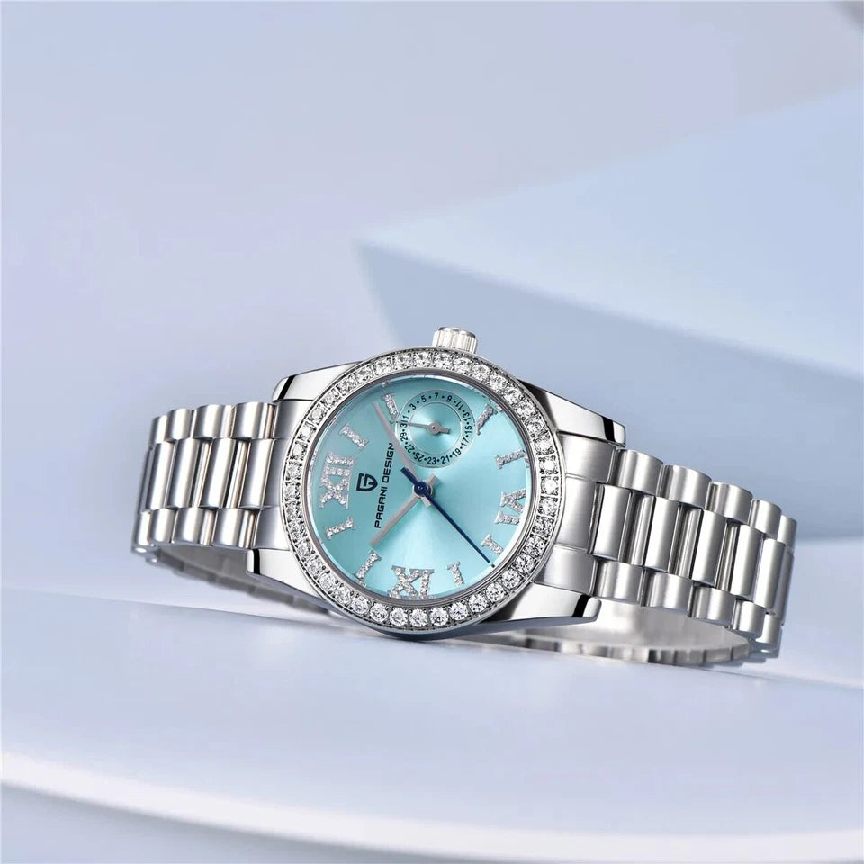 Silver watch with a blue face on a light blue background