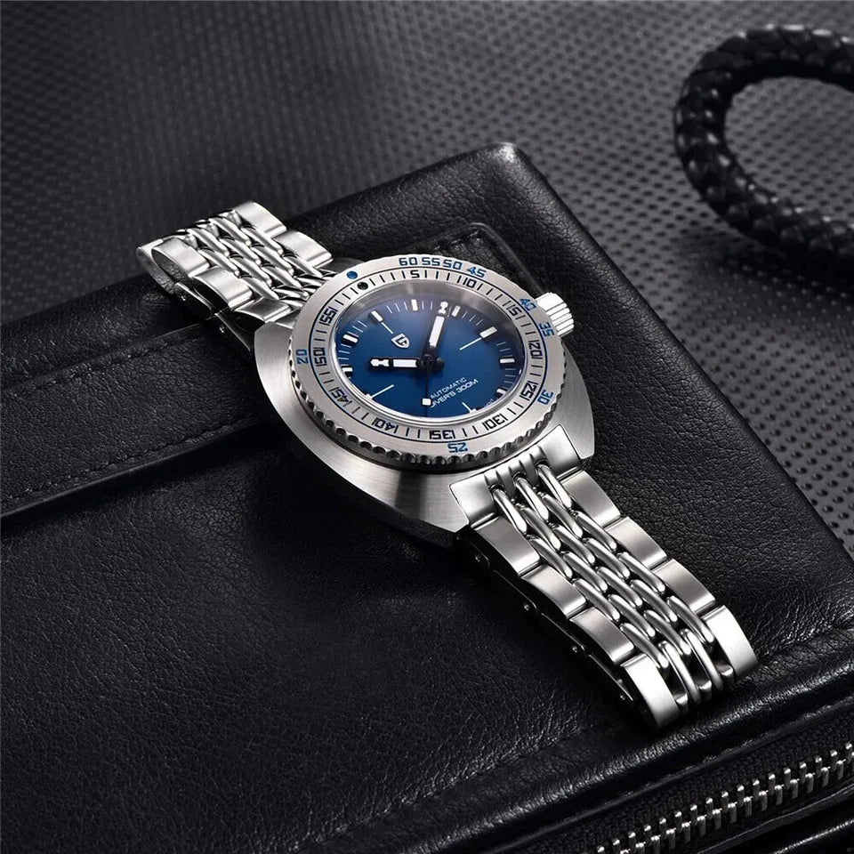 Silver watch with blue face on a black textured surface
