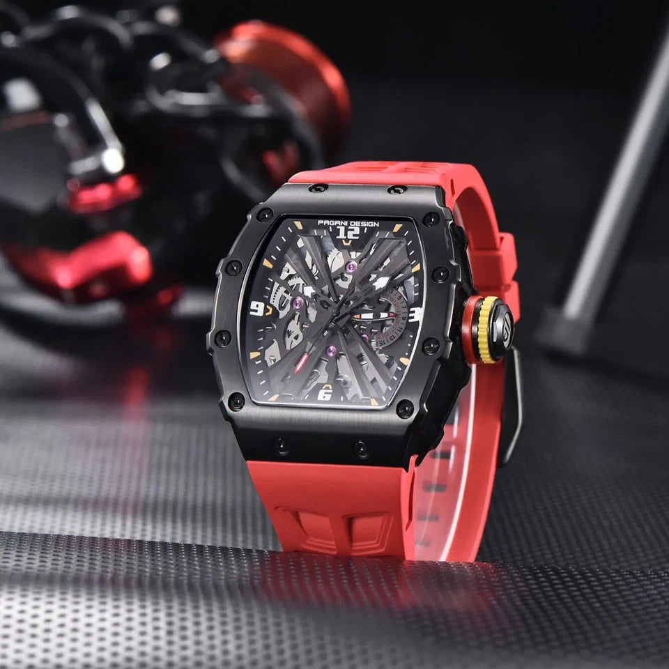 Luxury watch with red strap and black case on a reflective surface