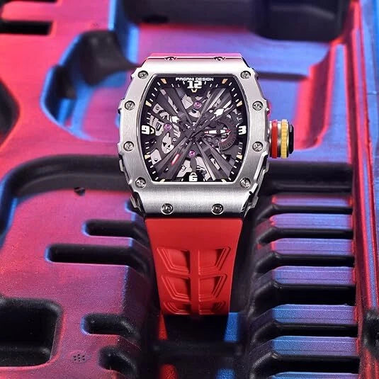 Watch with red strap and silver case on a textured surface