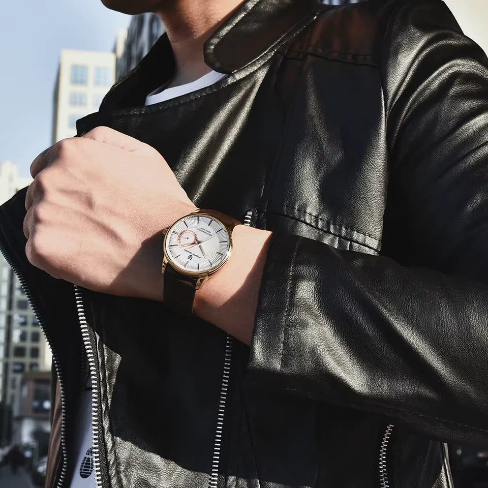 Person wearing a black leather jacket with a watch on their wrist, standing in an urban setting.