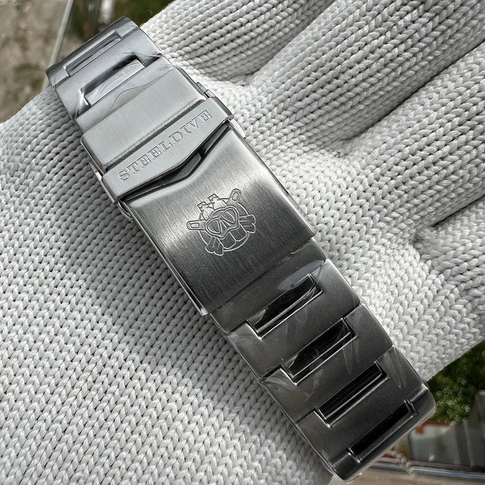 Metallic watch strap with brand logo on a textured fabric background