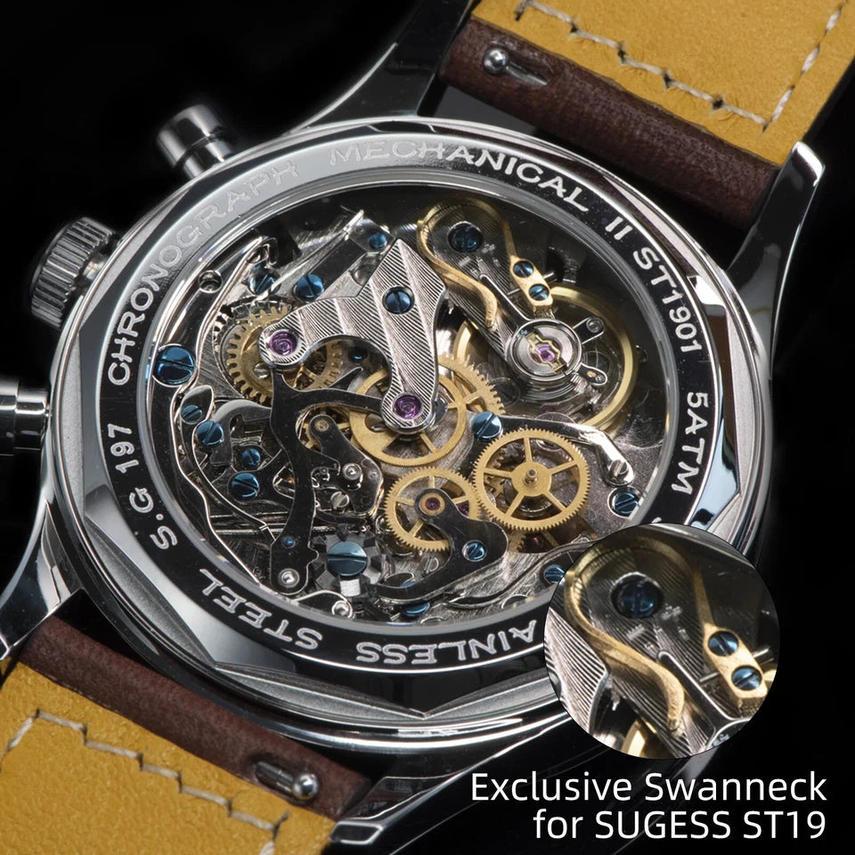 Close-up of a mechanical watch with visible swanneck design on a yellow strap.